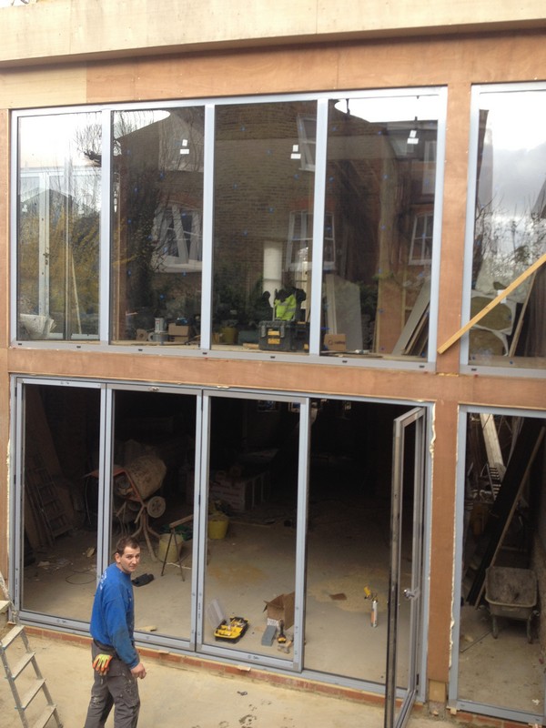 Aluminium bi-fold doors with two-storey glazing in Winchmore Hill