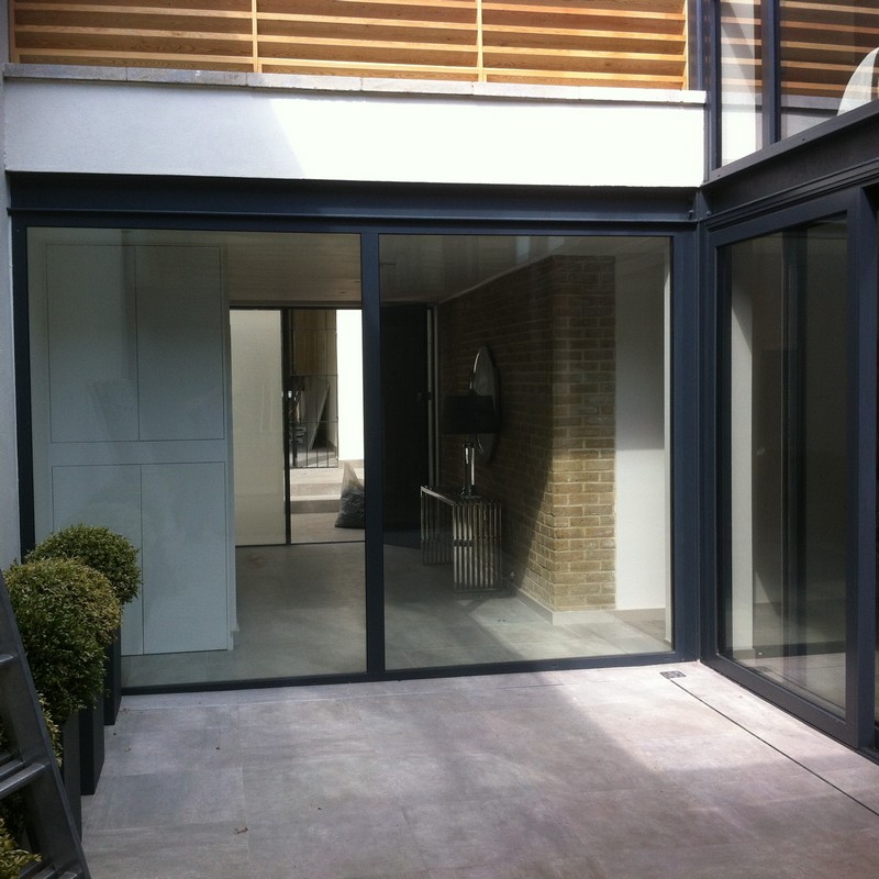Floor-to-ceiling sliding doors opening to courtyard in Winchmore Hill