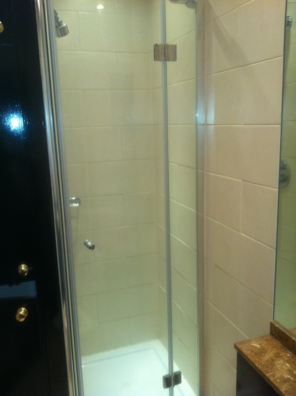 Frameless glass shower enclosure with chrome fittings in Winchmore Hill