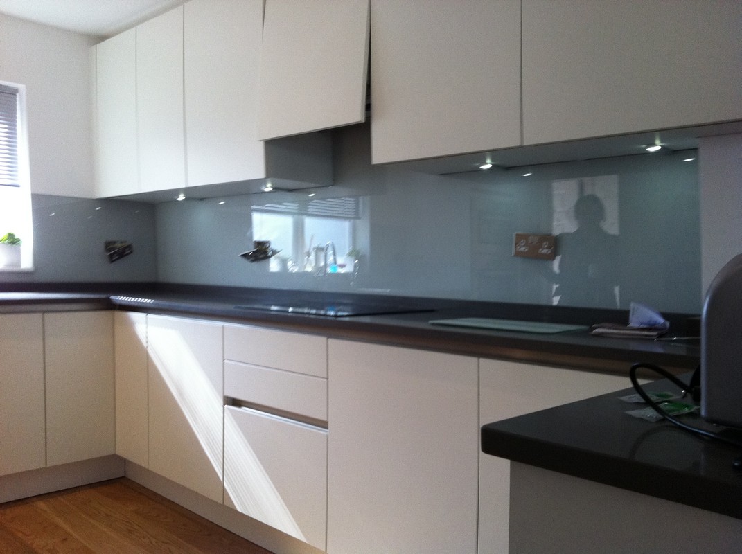 Grey glass kitchen splashback with LED lighting in Winchmore Hill
