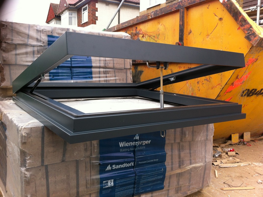 Opening flat roof skylight in anthracite grey installed in Winchmore Hill
